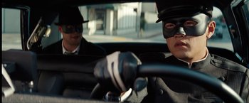 Movie still from “The Green Hornet” (2011), directed by Michel Gondry – Two people in a car wearing masks and riding in a car; Close Up shot, Low angle
