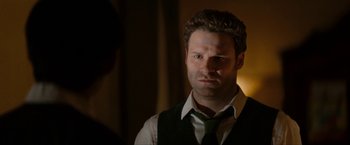 Movie still from “The Green Hornet” (2011), directed by Michel Gondry – A person wearing a vest and a neck tie; Close Up shot, Over the shoulder angle