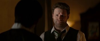 Movie still from “The Green Hornet” (2011), directed by Michel Gondry – A man wearing a vest and a green neck tie; Close Up shot, Over the shoulder angle