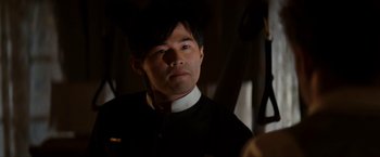 Movie still from “The Green Hornet” (2011), directed by Michel Gondry – A man wearing a black shirt and a red tie; Close Up shot, Over the shoulder angle