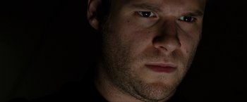 Movie still from “The Green Hornet” (2011), directed by Michel Gondry – A man's face in the dark; Close Up shot, Low angle