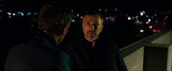 Movie still from “The Green Hornet” (2011), directed by Michel Gondry – A man in a black jacket is looking at another man in a black jacket; Close Up shot, Over the shoulder angle