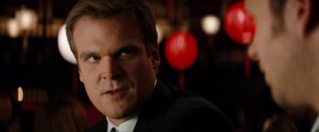 Movie still from “The Green Hornet” (2011), directed by Michel Gondry – A person wearing a suit and tie; Close Up shot, Over the shoulder angle