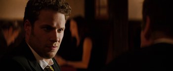 Movie still from “The Green Hornet” (2011), directed by Michel Gondry – A person wearing a suit and tie; Close Up shot, Over the shoulder angle