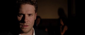Movie still from “The Green Hornet” (2011), directed by Michel Gondry – A person wearing a suit and tie; Close Up shot, Over the shoulder angle