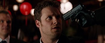 Movie still from “The Green Hornet” (2011), directed by Michel Gondry – A person holding a gun up to their head; Close Up shot, Over the shoulder angle