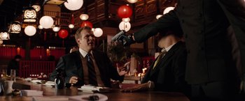 Movie still from “The Green Hornet” (2011), directed by Michel Gondry – Two men sitting at a table in a restaurant; Medium shot, Over the shoulder angle