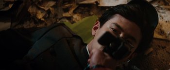 Movie still from “The Green Hornet” (2011), directed by Michel Gondry – A man holding a camera up to his face; Close Up shot, High angle