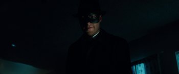 Movie still from “The Green Hornet” (2011), directed by Michel Gondry – A man wearing a green mask and a black suit; Close Up shot, Low angle