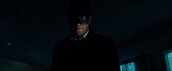 Movie still from “The Green Hornet” (2011), directed by Michel Gondry – A man wearing a black suit and a green mask; Close Up shot, Low angle