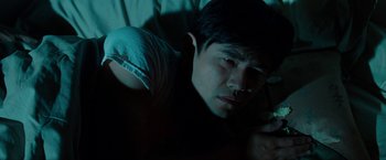 Movie still from “The Green Hornet” (2011), directed by Michel Gondry – A man laying in a bed looking at the camera; Close Up shot, Low angle