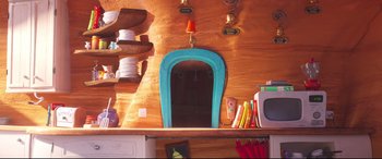 Movie still from “The Grinch” (2018), directed by Yarrow Cheney – A mirror hanging on the wall of a kitchen; Wide shot, High angle