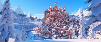 Movie still from “The Grinch” (2018), directed by Yarrow Cheney – A group of people sitting on top of a pile of candy; Extreme Wide shot, High angle