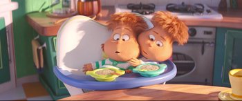 Movie still from “The Grinch” (2018), directed by Yarrow Cheney – A couple of stuffed animals sitting next to each other on top of a table; Medium shot, Overhead angle