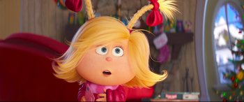 Movie still from “The Grinch” (2018), directed by Yarrow Cheney – A cartoon character's face with blonde hair; Close Up shot, Over the shoulder angle