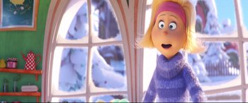 Movie still from “The Grinch” (2018), directed by Yarrow Cheney – A woman in a purple sweater looking out a window; Close Up shot, Over the shoulder angle