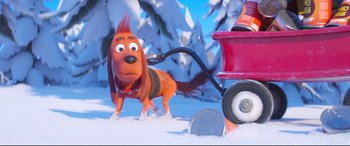 Movie still from “The Grinch” (2018), directed by Yarrow Cheney – A dog pulling a fire hydrant in the middle of a snowy field; Wide shot, High angle