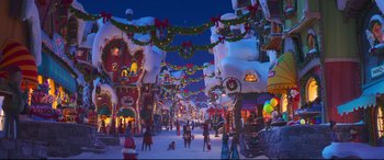 Movie still from “The Grinch” (2018), directed by Yarrow Cheney – A group of people standing in the middle of a street; Extreme Wide shot, High angle