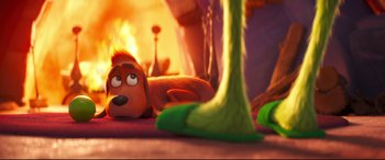 Movie still from “The Grinch” (2018), directed by Yarrow Cheney – A dog laying on the floor; Wide shot, Over the shoulder angle