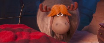Movie still from “The Grinch” (2018), directed by Yarrow Cheney – A moose's head with red hair; Close Up shot, Over the shoulder angle