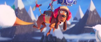 Movie still from “The Grinch” (2018), directed by Yarrow Cheney – A dog with headphones hanging from a camera; Wide shot, Overhead angle