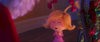 Movie still from “The Grinch” (2018), directed by Yarrow Cheney – A little girl with her eyes closed and her hands folded in front of her face; Close Up shot, Over the shoulder angle