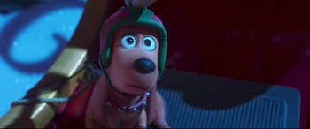 Movie still from “The Grinch” (2018), directed by Yarrow Cheney – A toy dog wearing a helmet and a neck brace; Close Up shot, High angle