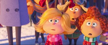 Movie still from “The Grinch” (2018), directed by Yarrow Cheney – A cartoon character's face with two other characters behind it; Close Up shot, Over the shoulder angle