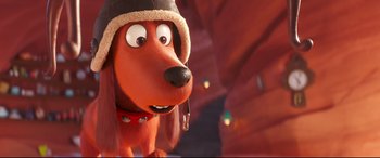 Movie still from “The Grinch” (2018), directed by Yarrow Cheney – A dog wearing a hat; Close Up shot, Over the shoulder angle