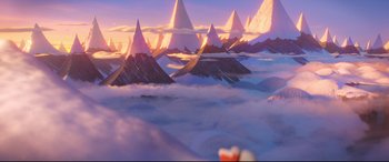 Movie still from “The Grinch” (2018), directed by Yarrow Cheney – An image of mountains in the sky at sunset; Extreme Wide shot, High angle