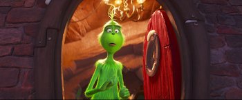 Movie still from “The Grinch” (2018), directed by Yarrow Cheney – The grinch standing in front of a red door; Medium shot, Over the shoulder angle