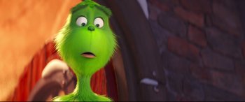 Movie still from “The Grinch” (2018), directed by Yarrow Cheney – The head of a green character; Close Up shot, Over the shoulder angle