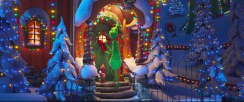 Movie still from “The Grinch” (2018), directed by Yarrow Cheney – A scene of the grinch holding a christmas tree; Extreme Wide shot, High angle