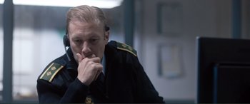 A man in a military uniform is sitting down