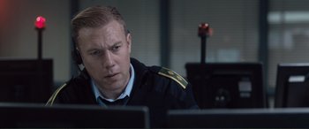 A man sitting in front of two computers