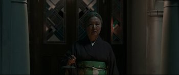 Movie still from “The Handmaiden” (2016), directed by Park Chan-wook – A woman in a kimono holding a cell phone in her hand; Medium shot, Low angle