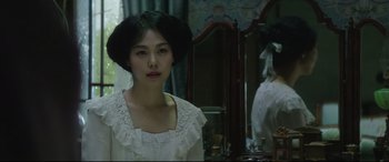Movie still from “The Handmaiden” (2016), directed by Park Chan-wook – A woman in a white dress standing in front of a mirror; Close Up shot, Over the shoulder angle