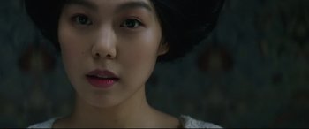 Movie still from “The Handmaiden” (2016), directed by Park Chan-wook – A young woman's face; Close Up shot, Over the shoulder angle