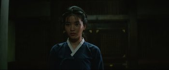 Movie still from “The Handmaiden” (2016), directed by Park Chan-wook – A young asian woman wearing a blue and white shirt; Close Up shot, Over the shoulder angle