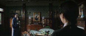 A person is sitting at a table in front of a mirror