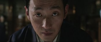 Movie still from “The Handmaiden” (2016), directed by Park Chan-wook – A man's eyes and face; Extreme Close Up shot, Low angle