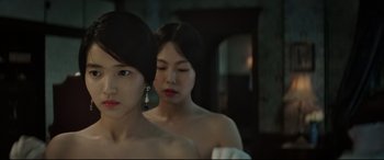 Movie still from “The Handmaiden” (2016), directed by Park Chan-wook – Two young asian women standing next to each other; Close Up shot, Over the shoulder angle