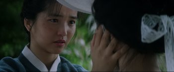 Movie still from “The Handmaiden” (2016), directed by Park Chan-wook – A young woman is looking at a woman on a cell phone; Close Up shot, Over the shoulder angle