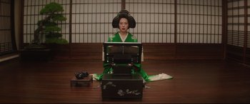 Movie still from “The Handmaiden” (2016), directed by Park Chan-wook – A geisha sitting in front of an open laptop computer; Medium shot, Low angle
