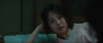 Movie still from “The Handmaiden” (2016), directed by Park Chan-wook – A beautiful young lady sitting on top of a couch; Close Up shot, Low angle