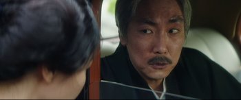 Movie still from “The Handmaiden” (2016), directed by Park Chan-wook – A man looking into a mirror while a woman looks on; Close Up shot, Over the shoulder angle