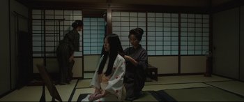 Movie still from “The Handmaiden” (2016), directed by Park Chan-wook – A woman is getting her hair done in a kimono; Medium shot, Over the shoulder angle