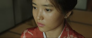 Movie still from “The Handmaiden” (2016), directed by Park Chan-wook – A person wearing a red shirt; Close Up shot, High angle