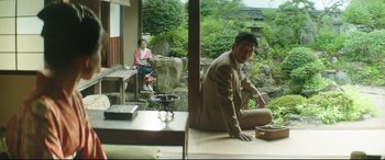 Movie still from “The Handmaiden” (2016), directed by Park Chan-wook – A man sitting on the ground next to a woman; Wide shot, Low angle