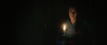 Movie still from “The Handmaiden” (2016), directed by Park Chan-wook – A person holding a candle in a dark room; Medium shot, Low angle